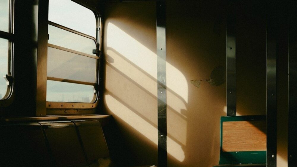 Interior vacío de un vagón de tren bañado por la luz del sol